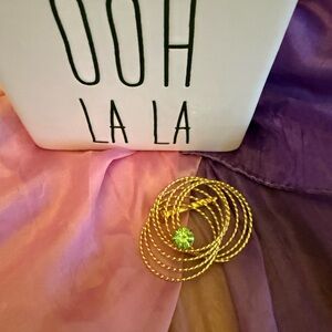 Vintage Gold Tone Swirl Brooch with a Faux Green Peridot